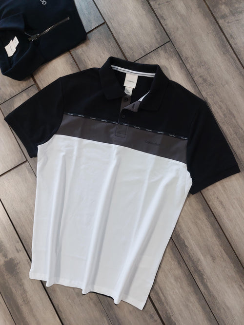  celvin klein Black and white polo shirt on a wooden floor